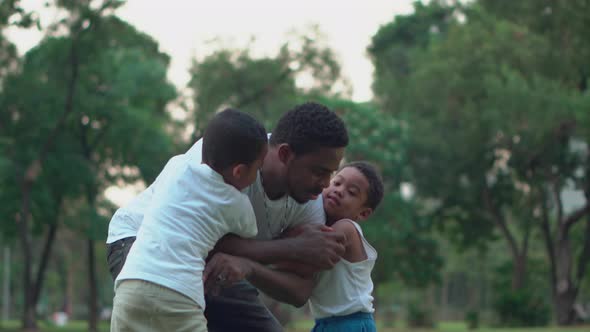 Dark Son And Dad, African American father and two sons playing at outdoor, Happiness family concepts