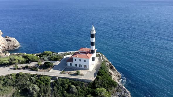 Portocolom lighthouse on cliff at the sea, Mallorca, Spain alt