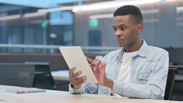 African Man using Tablet in Office alt