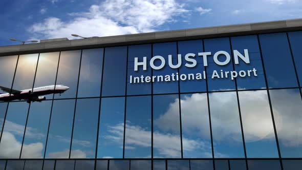 Airplane landing at Houston Texas mirrored in airport terminal by Vipho