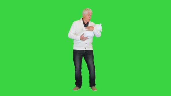 Grandfather Standing and Holding Grandson on a Green Screen Chroma Key alt