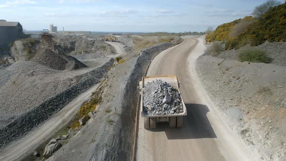 Mine Truck Driving Ore to a Processing Plant alt