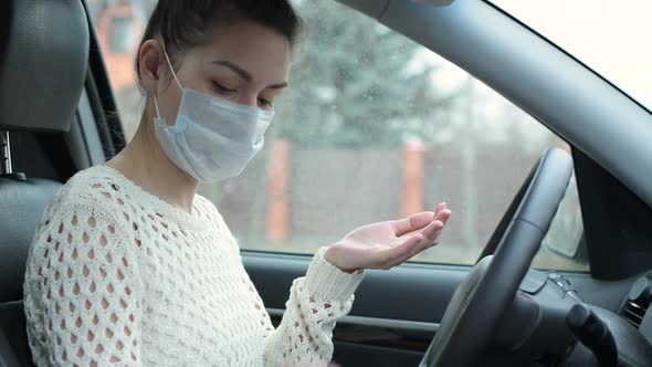 Young woman disinfects her hands with an antibacterial gel after a meeting alt