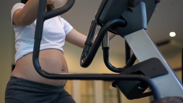 Active Pregnant Woman Exercise in Fitness Center alt