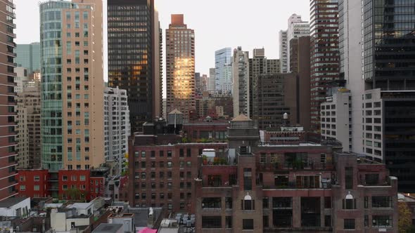 Forwards Fly Between Tall Apartment Buildings in City alt