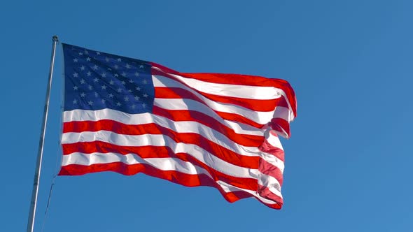 American Flag Flying in the Wind at Sunny Day