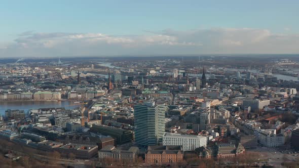 Wide Aerial View of Hamburg City Center with Tall Churches and Landmarks Rising Above Urban alt