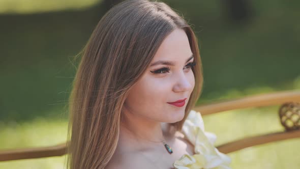 A Young Girl Poses in a Park in the Summer