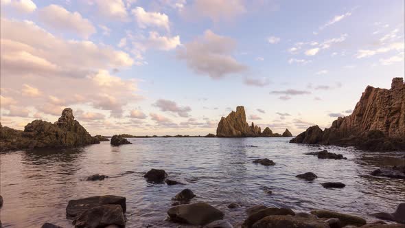 Fast moving clouds in a seascape in El Arrecife de las Sirenas, Cabo de Gata alt