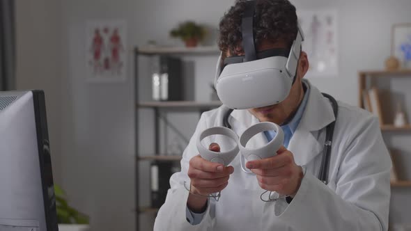 Professional Young Man Doctor Working in Hospital Office Using Virtual Reality Technology alt
