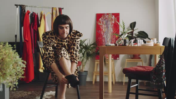 Transgender Man Putting on Tights at Home alt
