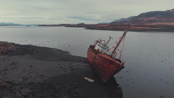 Rusty ship near river coast alt