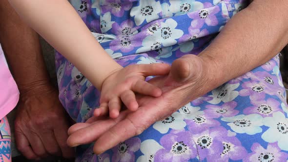 Old Wrinkled Hands Touch and Clap Kid Soft Hands. Closeup Hands of Grandchild and Grandmother
