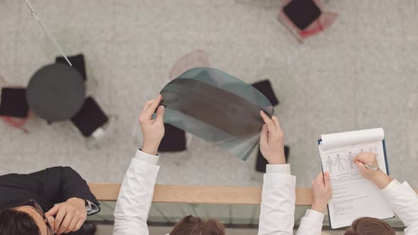 Medical Team Examining Bone Xray of Patient alt