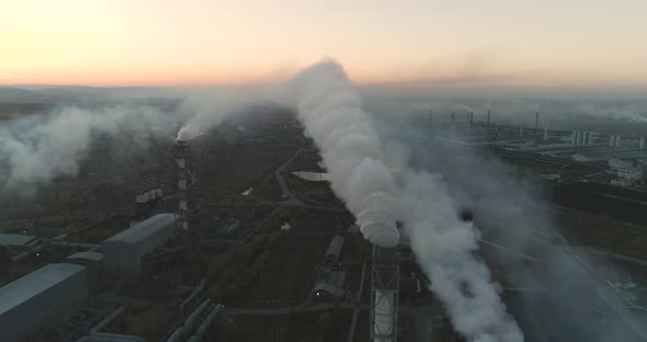 Aerial Veiw Of High Smokestack With Smoke Emission. Plant Pipes Pollute Atmosphere. alt