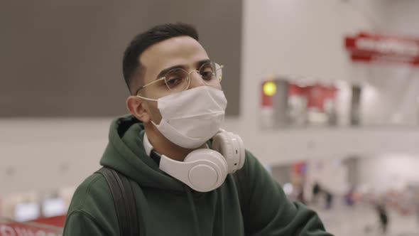 Closeup Of Man In Headphones In Airport alt