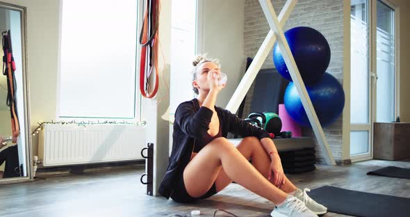 Good Looking Curly Hair Lady Drinking Some Water alt
