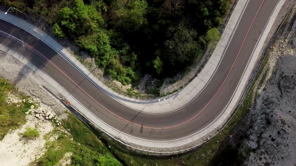 Top Down View of Winding Mountain Road with Cars alt