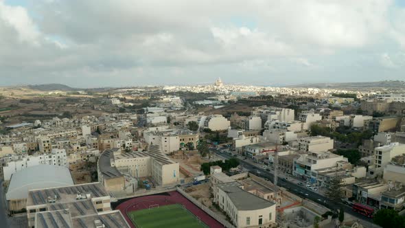 Fast Moving Hyperlapse Over Gozo Island, Malta with Church in Distance and Overcast Sky, Aerial alt