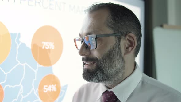 Closeup of Businessman in Glasses Talking About Project alt