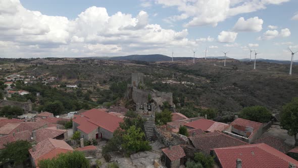 Ancient Sortelha Fortress on bluff overlooking countryside; aerial pan