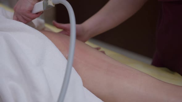 Top View Massaging of Female Thigh and Buttock with Antricellulite Machine in Beauty Spa alt