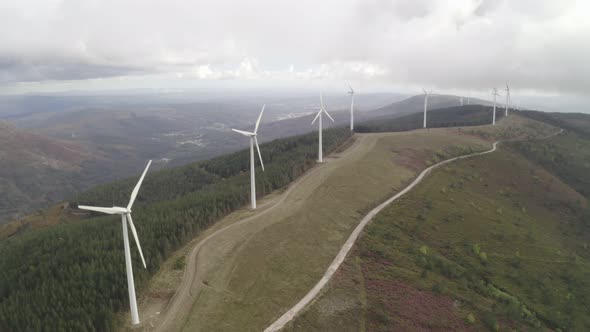 Aerial drone view of wind turbines renewable energy on the middle of clouds in Serra da Lousa alt