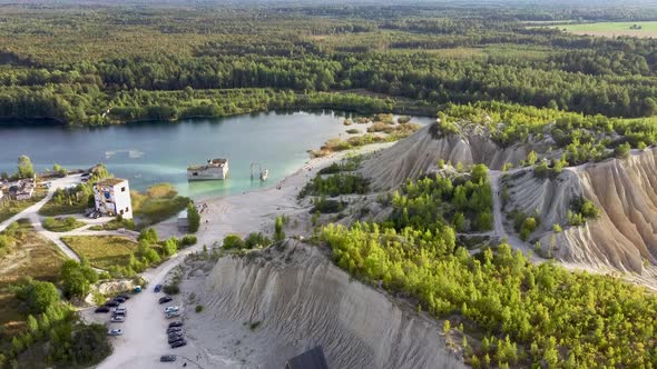 Aerial landscape Sand Hills of Quarry With a Pond and Abandoned Prison in Rummu Estonia Europe. Floo alt
