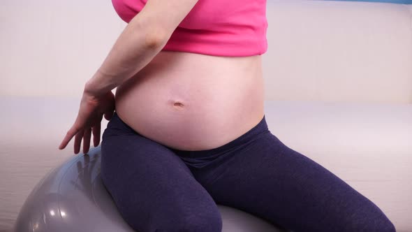 Pregnant Woman Exercising on Gym Ball