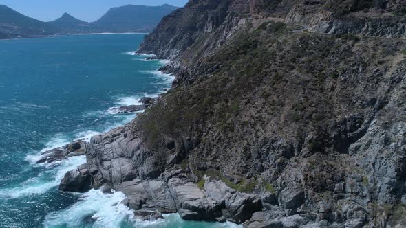 Drone flying above dramatically rugged coastline of Cape Peninsula - Chapman's Peak Drive, South Afr alt