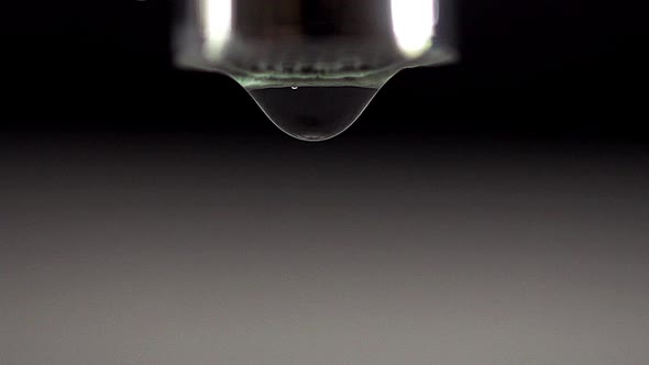 750474 Drop by Drop of Water falling from Tap against White background, Real Time alt