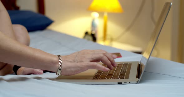 Middle age male hands using notebook for work from home
