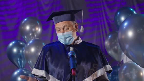Male Rector in Medical Mask on Face Observes Safety Measures and Presents Diploma Online Via Video alt