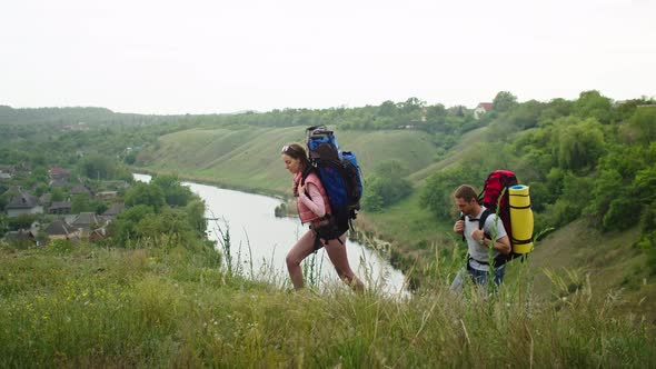 Happy Couple Man and Woman in the Mountains Travel in Search of a Vacation Spot alt