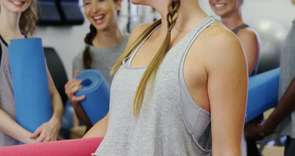 Beautiful women standing in fitness studio alt