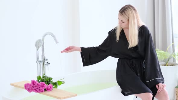 Young Beautiful Woman Takes Water in the Bath alt