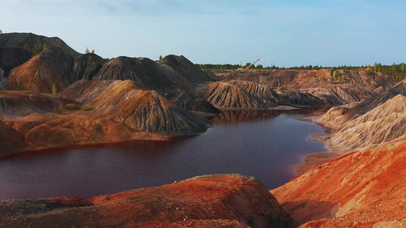 Aerial View of a Landscape Similar To the Planet Mars with Red Hills and Rivers with Red Water alt