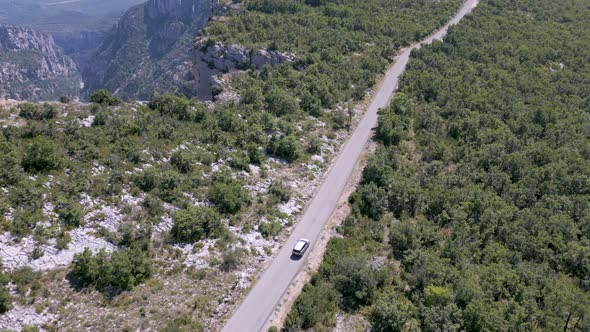 Aerial shot of a car driving at Verdon Gorge (Gorges du Verdon), France alt