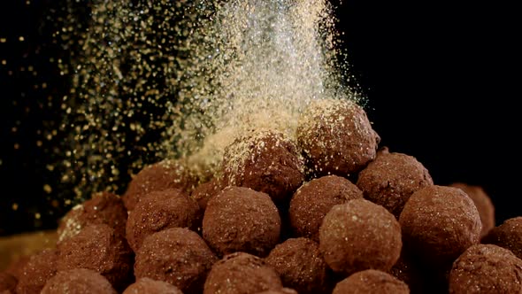 Golden Dust Falls on Rotating Handmade Luxury Truffle Close Up Slow Mo