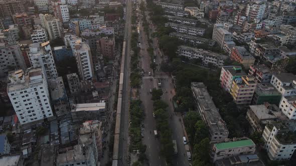 Drone flight shows train and traffic flow along highway in Dhaka city, Bangladesh alt