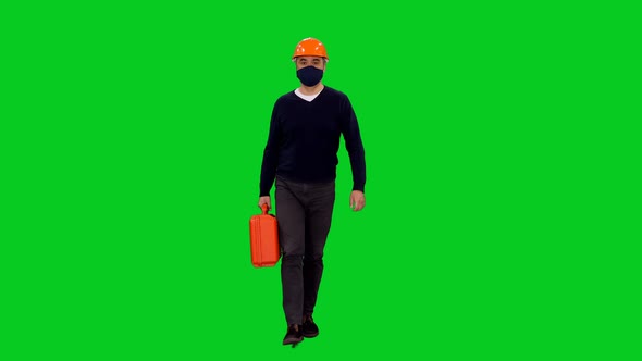 Architect In Protective Mask And Hard Hat Stumbling While Walking