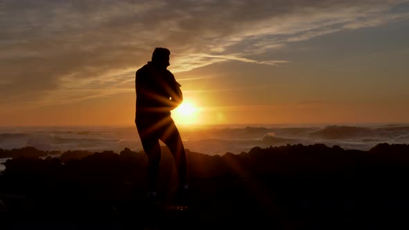 Men Warrior Monk Practicing Silhouette Tai Chi Karate Kung Fu on the Rocky Stones Horizon at Sunset alt