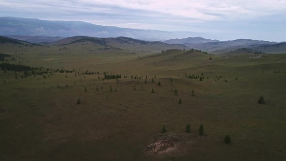 Baikal Valley spirits,Tazheran Steppe, Stone Cliffs on the Road. Aerial Summer alt