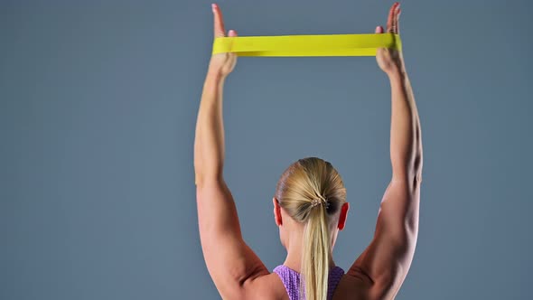 Woman Doing Exercises with an Elastic Band