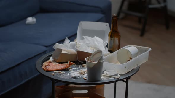 Close Up of Leftover Food on Table in Empty Messy Living Room alt