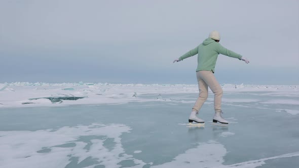 Girl Skates on The Icy Surface of Lake Baikal