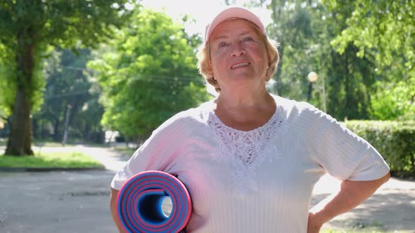 Happy woman of retirement age enjoys life on a nice sunny summer day. alt