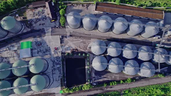Commercial Grain Or Seed Silos In Sunny Spring Rural Landscape alt