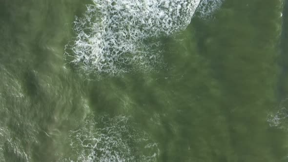 AERIAL: Top View Ascending Shot of Waves of Baltic Sea on Windy Day alt
