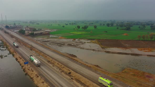 Exterior View of traffic near Green farm in Pakistan. alt